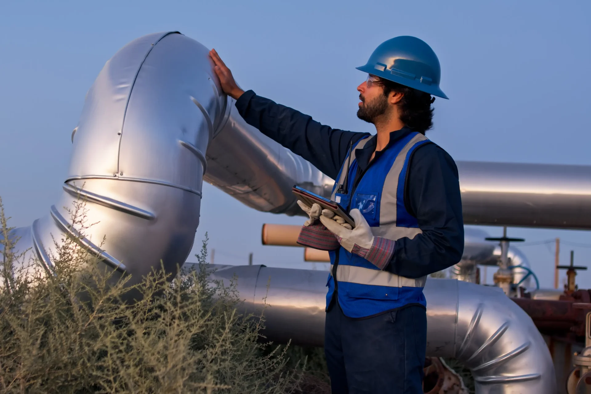 A man stands beside a large object, showcasing its size and scale in the environment.